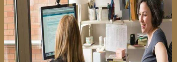 A librarian and a student talk in an office